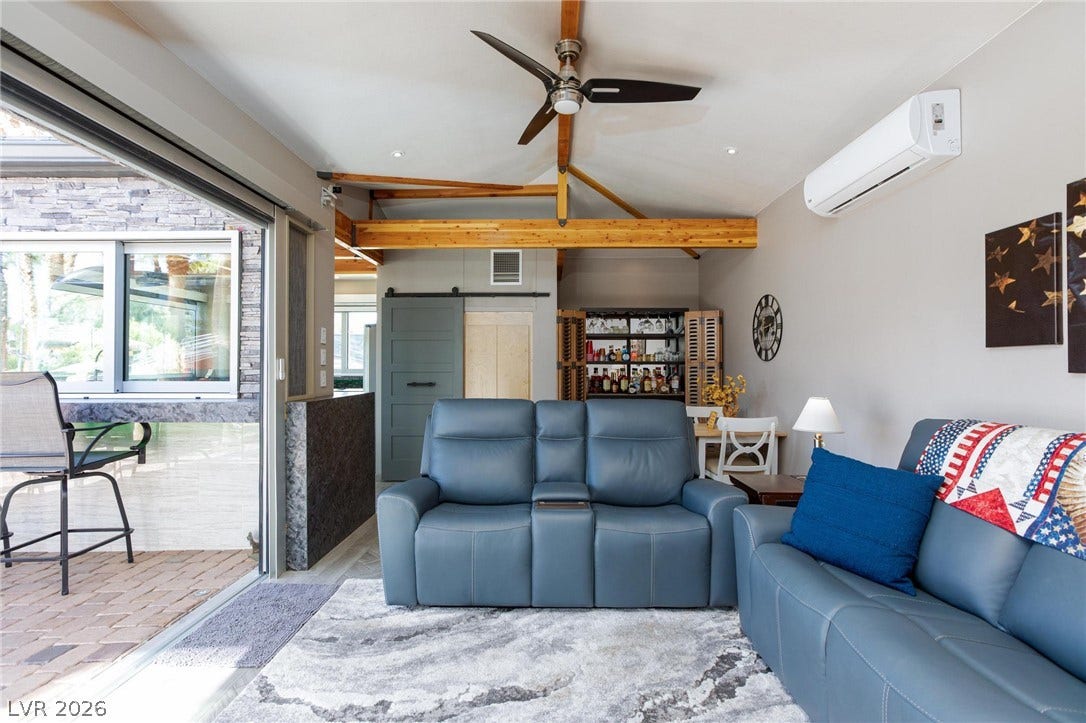 8175 Arville Street, #142, Las Vegas, NV 89139 Exposed wood beams and a massive sliding glass door define this airy living space.