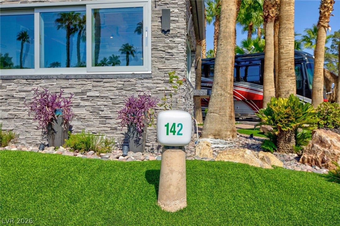 8175 Arville Street, #142, Las Vegas, NV 89139 Textured stone siding and manicured green lawns create an inviting exterior entry.