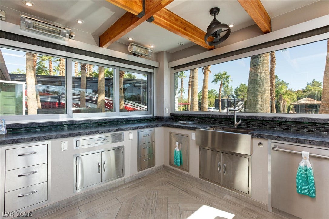 8175 Arville Street, #142, Las Vegas, NV 89139 Exposed wood beams and massive picture windows frame this fully equipped outdoor culinary space.