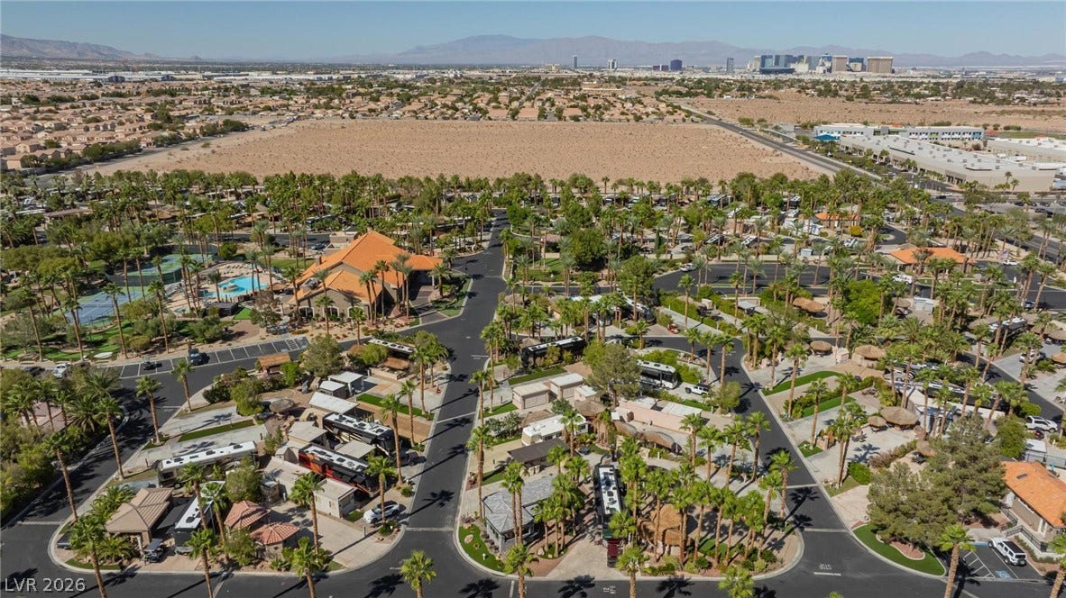 8175 Arville Street, #142, Las Vegas, NV 89139 An aerial perspective showcases a palm-shaded community nestled against a desert valley landscape.