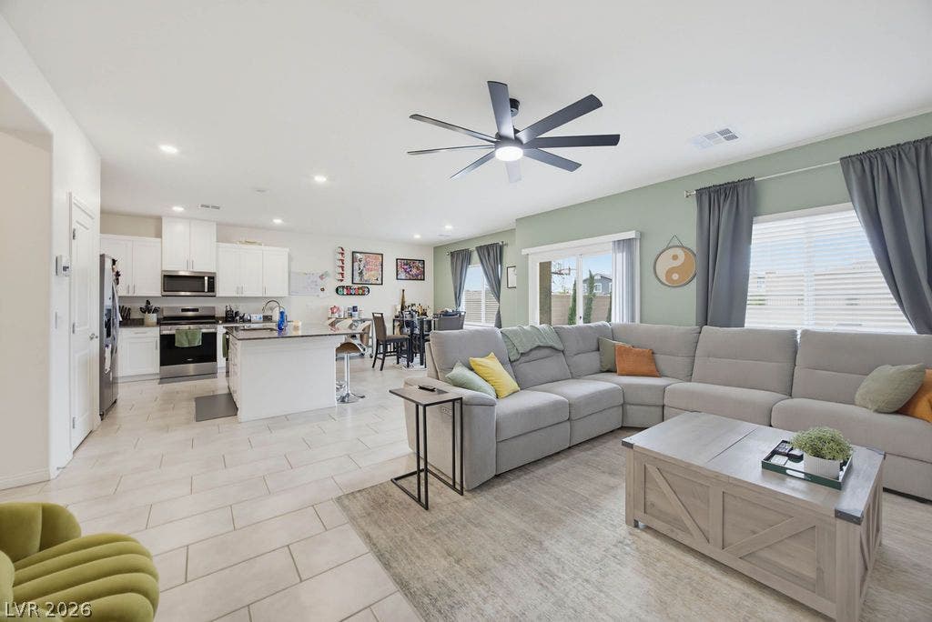 An open floor plan seamlessly connects the main living spaces over durable tile flooring.