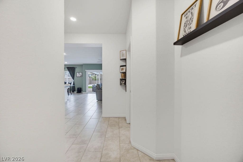 An inviting entryway leads directly into the open living spaces with sleek tile flooring.