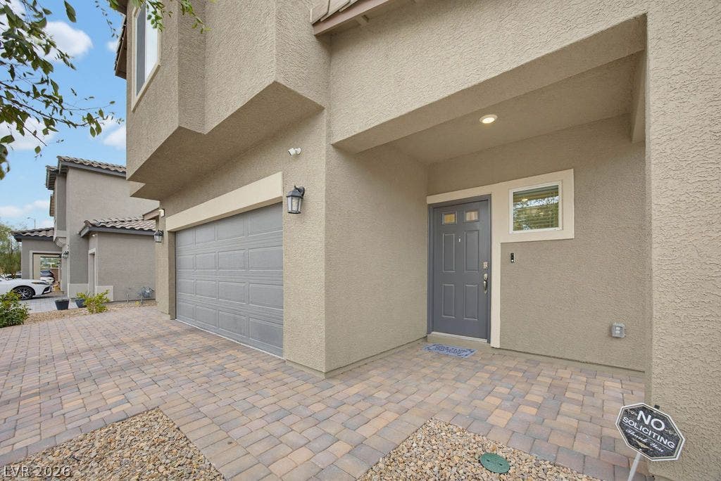 An inviting recessed entryway and paved driveway lead to the multi-car garage.