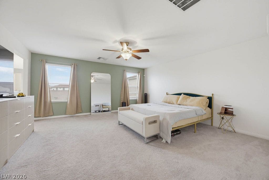 Soft wall-to-wall carpeting and symmetrical windows anchor this peaceful retreat.