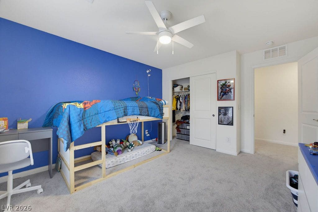 A well-proportioned bedroom features soft carpeting and direct access to the hallway.