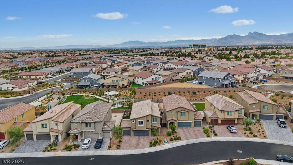 Majestic mountain ranges frame a sprawling suburban neighborhood of beautifully crafted modern homes.