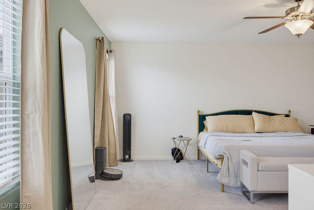 Plush carpeting and natural light define this restful space.