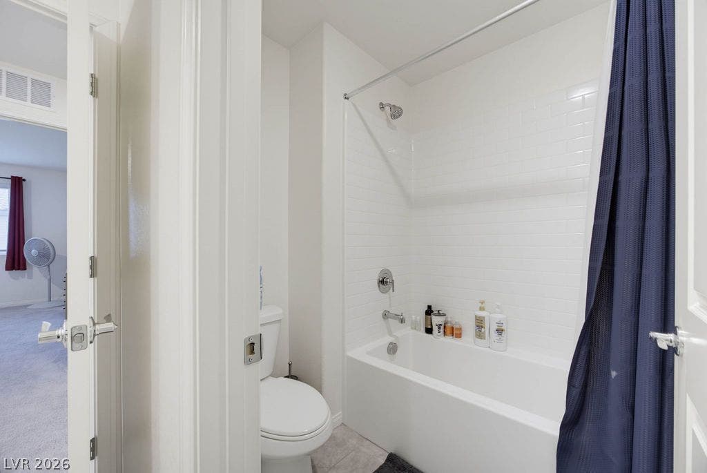 Crisp subway tile surrounds the shower and tub in this clean bathroom.
