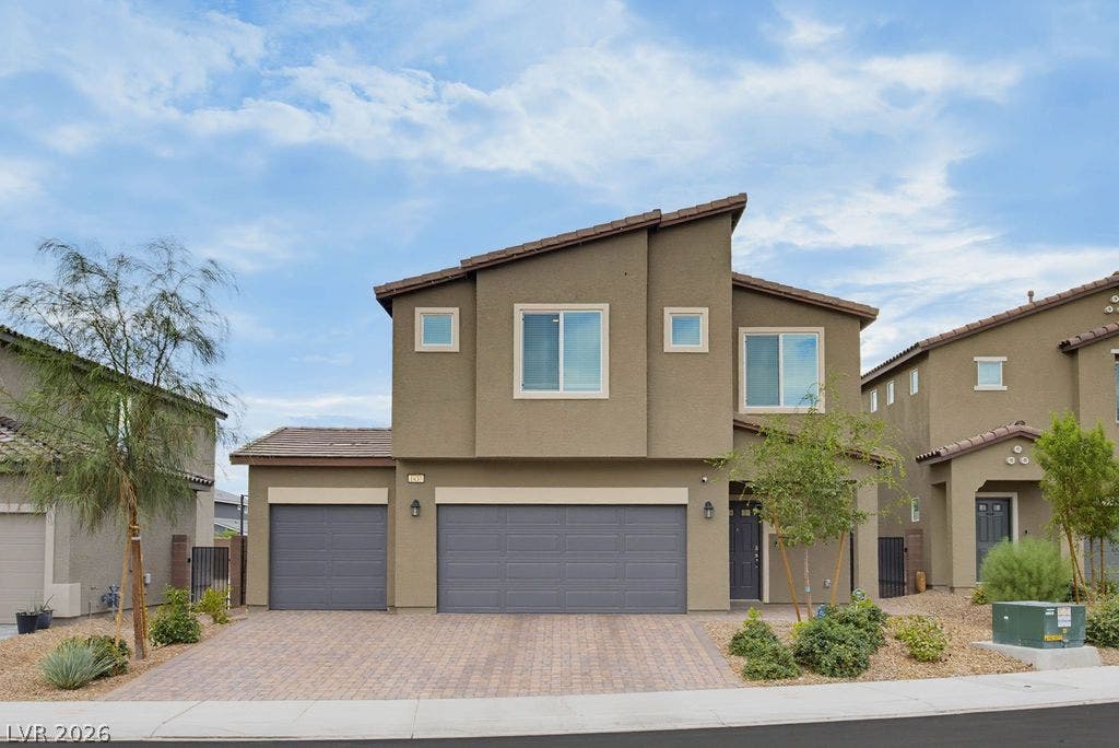 Clean lines and a paved driveway define this contemporary two-story home with stucco siding.