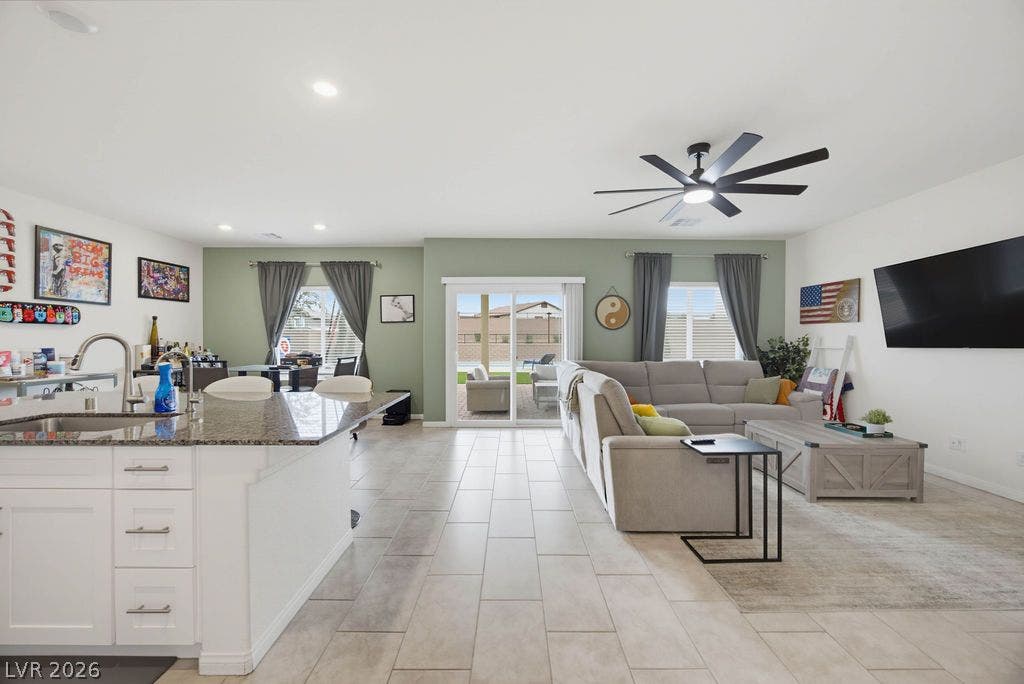 Smooth tile flooring and sliding glass doors define this open-concept main level living area.