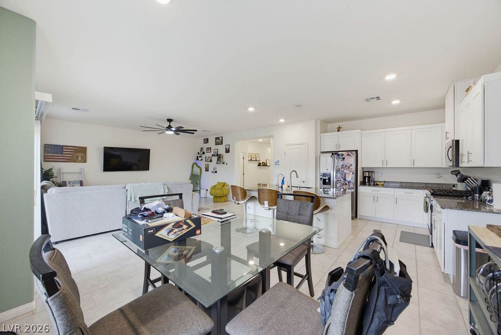 An open-concept layout seamlessly connects the kitchen and living spaces under recessed lighting.