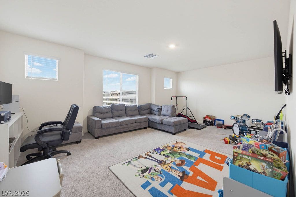 Generous windows fill this versatile bonus space with natural light.