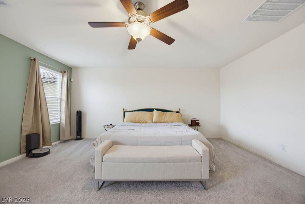 Soft carpet flooring and ample wall space define this comfortable sleeping area.