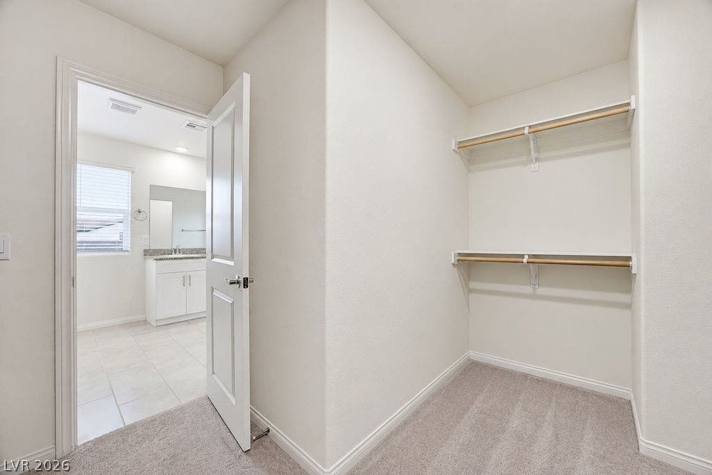Ample shelving options highlight this functional storage space steps away from the bath.