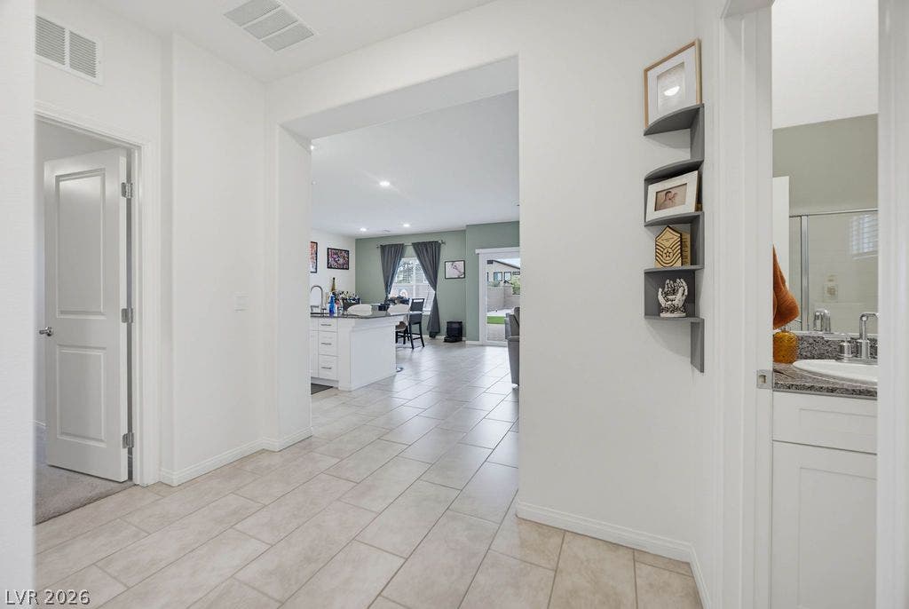 Tiled flooring and broad arched openings create an airy flow through this inviting entry way.