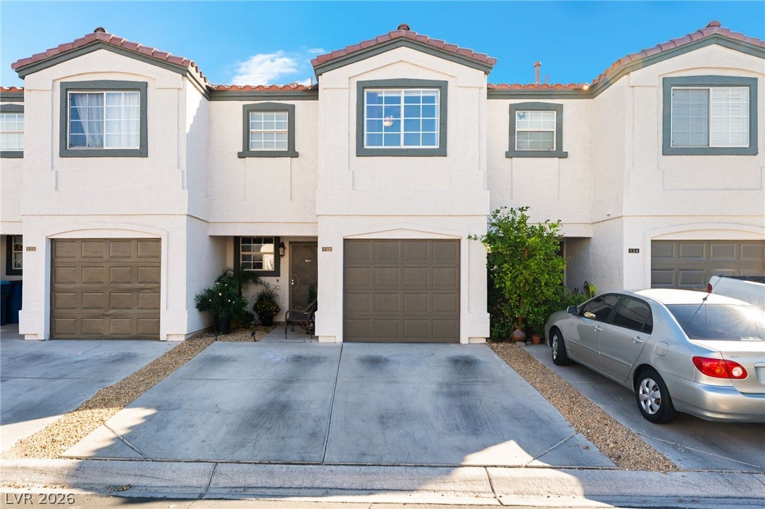 5330 E Charleston Boulevard, #123, Las Vegas, NV 89142 A classic exterior architecture details this multi-level stucco townhouse featuring integrated garage storage.