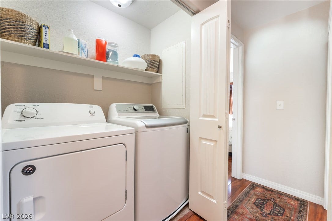 5330 E Charleston Boulevard, #123, Las Vegas, NV 89142 A dedicated laundry closet features built-in shelving and rich wood flooring.