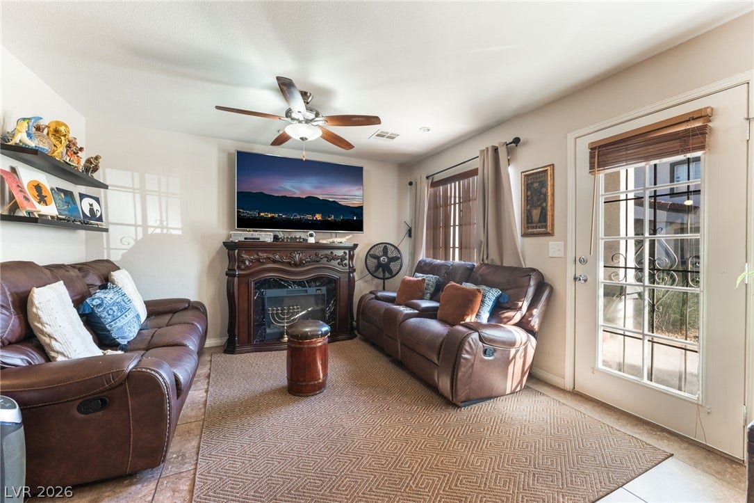 5330 E Charleston Boulevard, #123, Las Vegas, NV 89142 An inviting family room offers tiled flooring and an elegant fireplace with an ornate mantel.