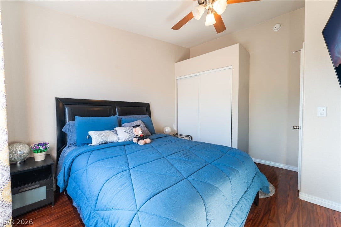 5330 E Charleston Boulevard, #123, Las Vegas, NV 89142 Rich wood-inspired floors and clean walls anchor this inviting bedroom space.