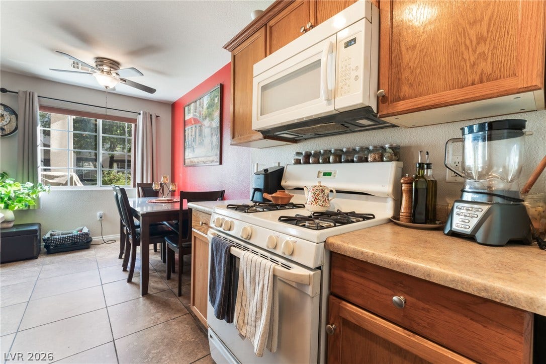 5330 E Charleston Boulevard, #123, Las Vegas, NV 89142 Warm wood cabinetry and tile flooring anchor this functional cooking and dining space.
