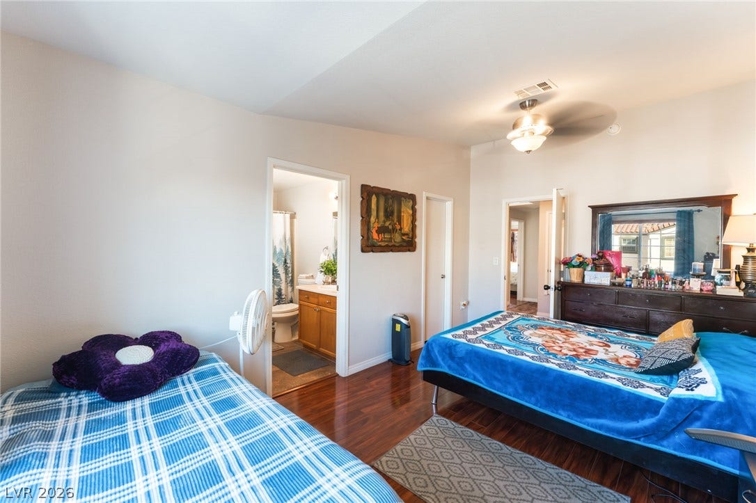 5330 E Charleston Boulevard, #123, Las Vegas, NV 89142 Rich hardwood floors anchor this bedroom featuring an attached private bathroom.