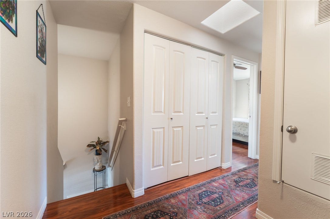 5330 E Charleston Boulevard, #123, Las Vegas, NV 89142 A spacious upper hallway boasts warm wood flooring and an overhead skylight.