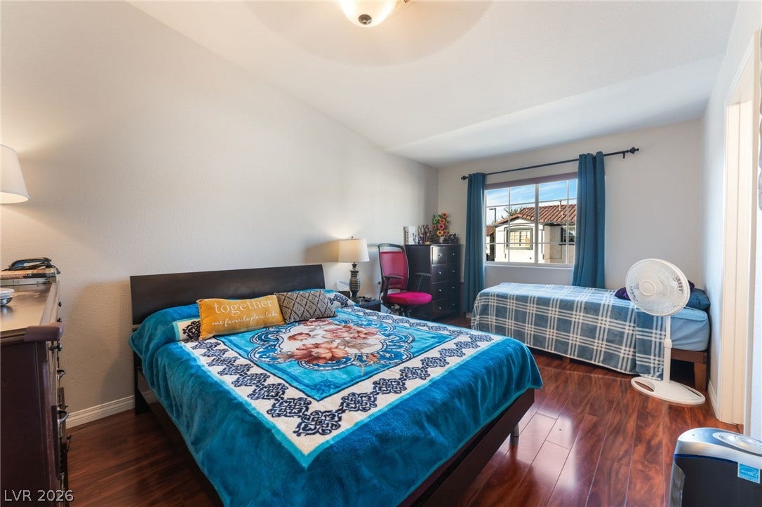 5330 E Charleston Boulevard, #123, Las Vegas, NV 89142 Rich hardwood flooring complements the neutral walls and natural light in this cozy bedroom.