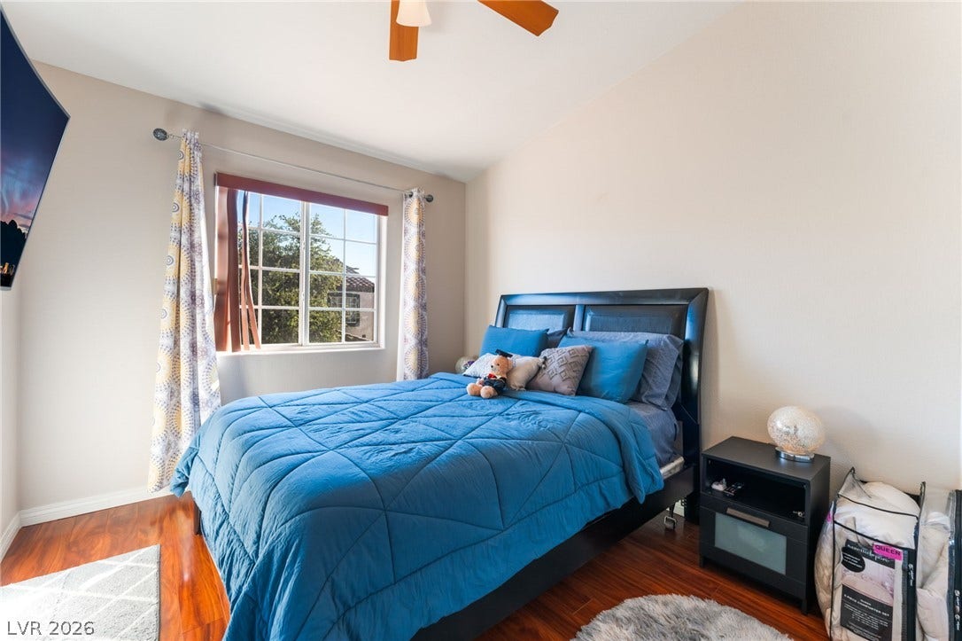 5330 E Charleston Boulevard, #123, Las Vegas, NV 89142 Gleaming hardwood floors and a large multi-pane window elevate this comfortable bedroom space.