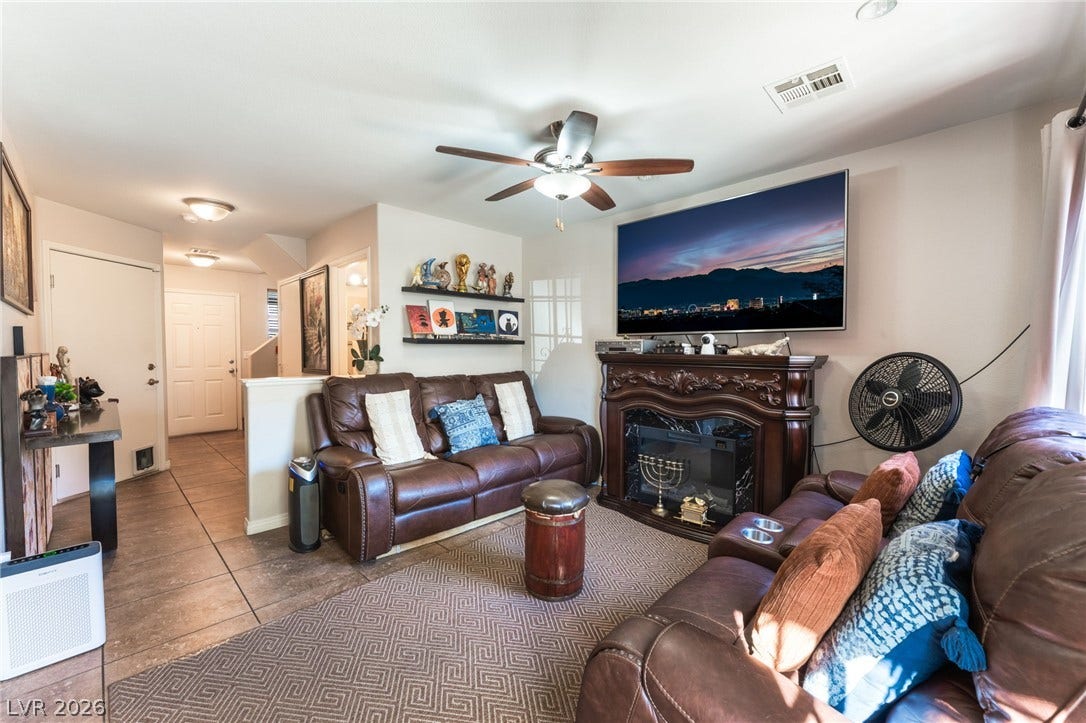 5330 E Charleston Boulevard, #123, Las Vegas, NV 89142 An inviting hearth and durable tile flooring define this open living space.