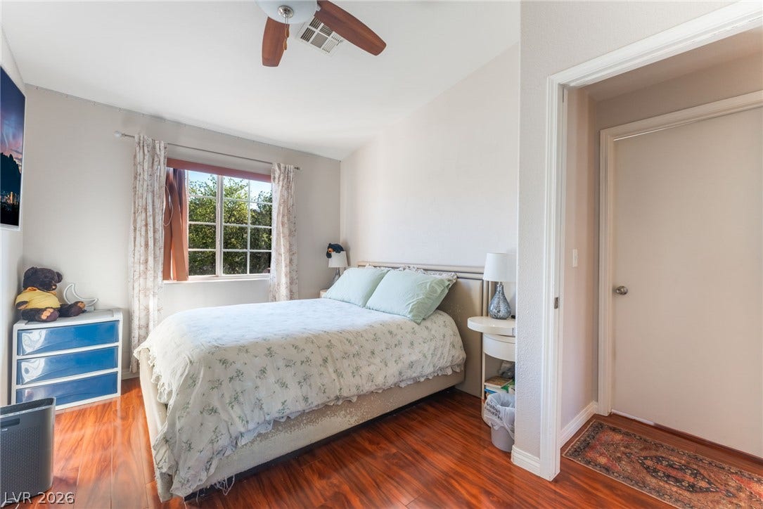 5330 E Charleston Boulevard, #123, Las Vegas, NV 89142 Warm wood flooring grounds this cozy bedroom, filled with natural light from a multi-pane window.