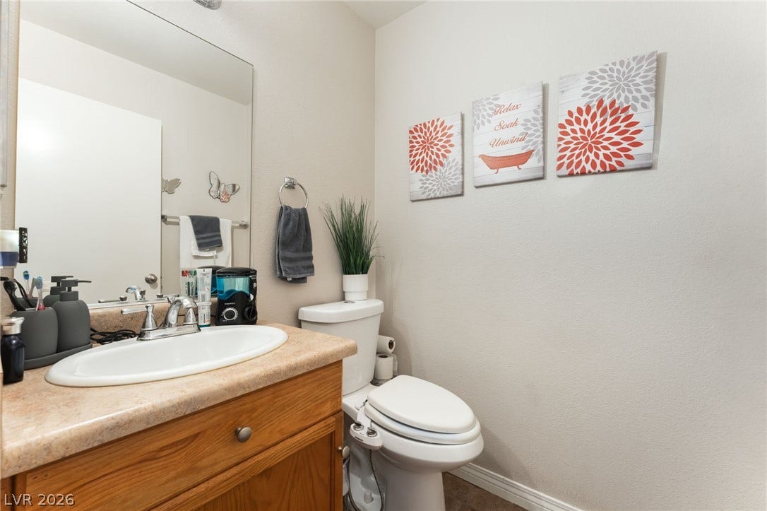 5330 E Charleston Boulevard, #123, Las Vegas, NV 89142 A classic wooden vanity anchors this bathroom with functional counter space.