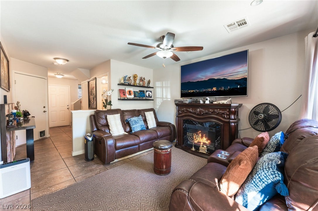 5330 E Charleston Boulevard, #123, Las Vegas, NV 89142 An inviting fireplace and tile flooring anchor this comfortable living area.