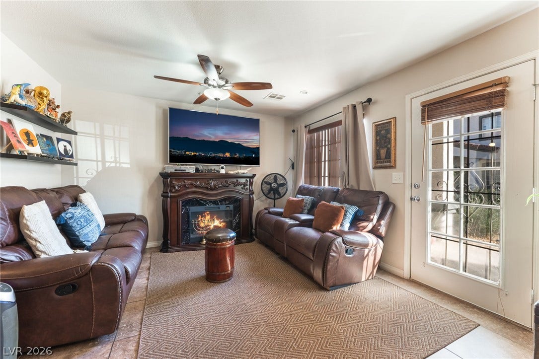 5330 E Charleston Boulevard, #123, Las Vegas, NV 89142 An ornate fireplace anchors this cozy living space complete with a glass-paneled exterior door.