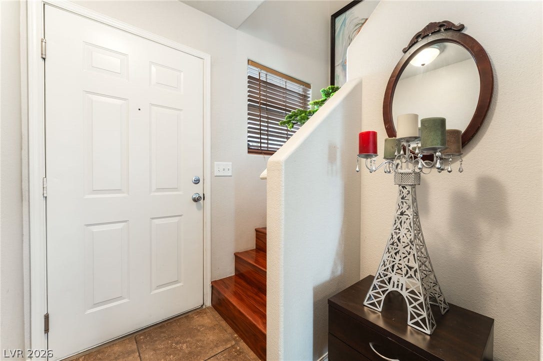 5330 E Charleston Boulevard, #123, Las Vegas, NV 89142 Rich wood stairs and warm tile flooring welcome visitors inside the front entry.
