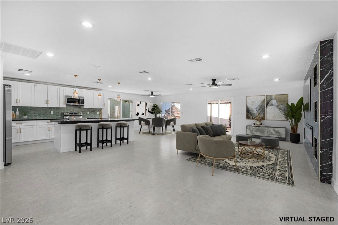 An open floor plan seamlessly connects the kitchen with the spacious dining and living areas.