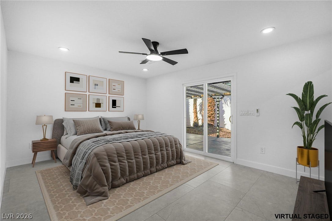 Sliding glass doors open directly to the outdoor patio from this modern bedroom.