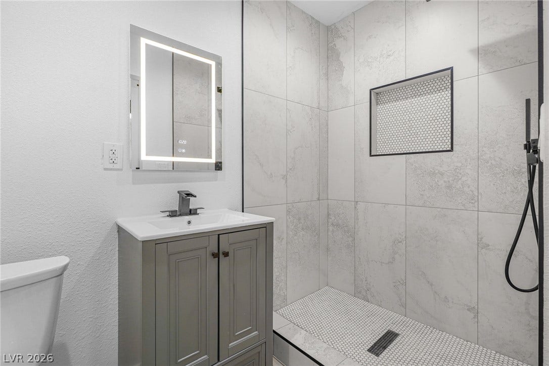 Clean lines and modern tile finishes define this beautifully renovated bathroom.