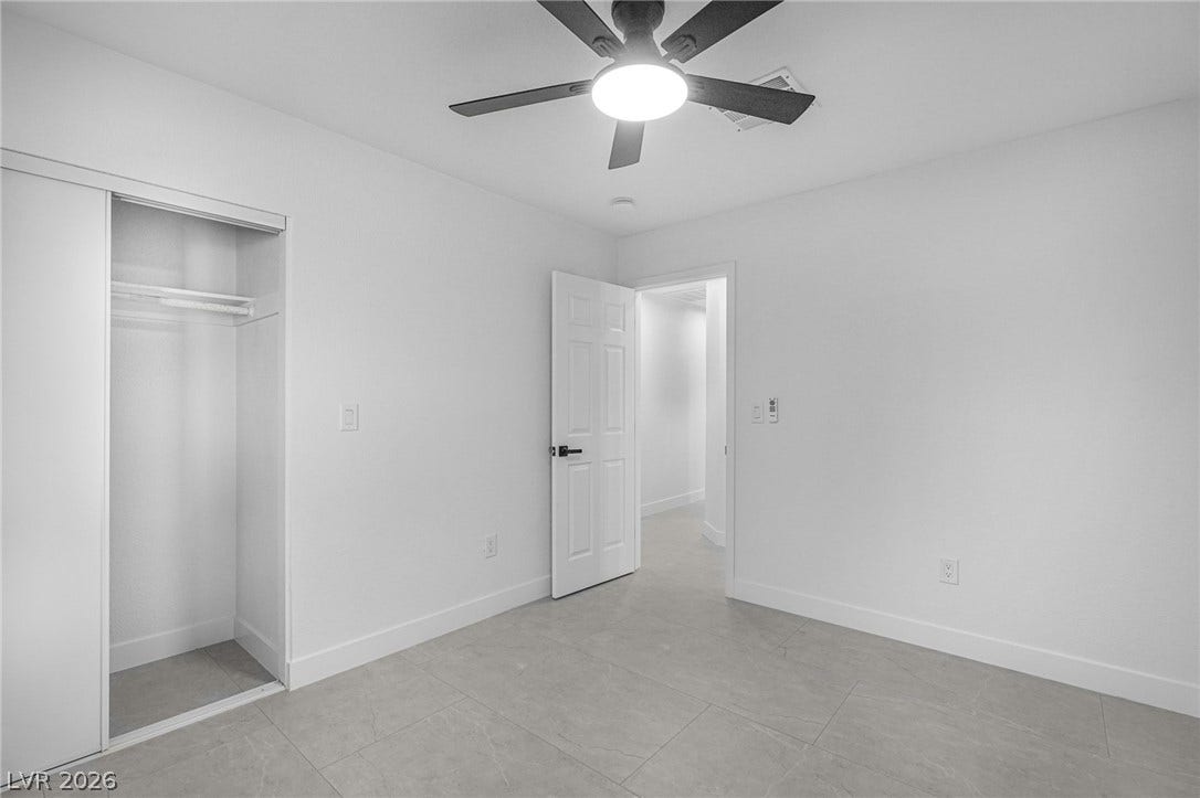 Crisp white walls and modern tile flooring define this minimalist interior space.