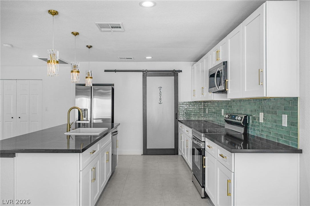 Modern cabinetry and a central island ground this contemporary kitchen space.