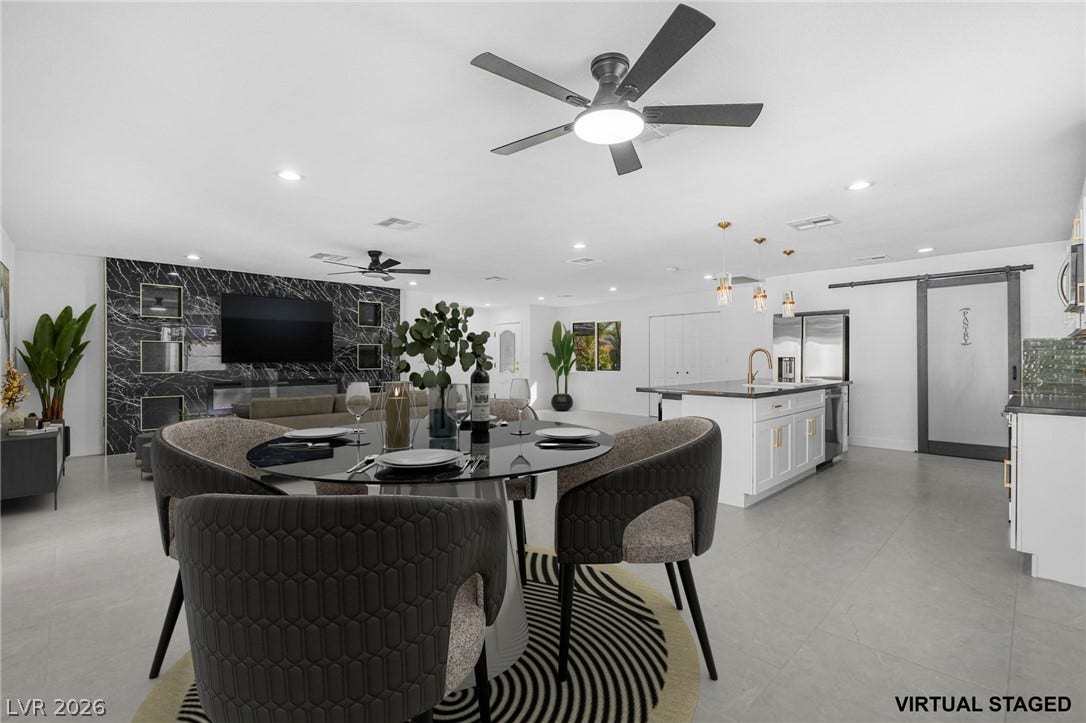 Gleaming tile floors anchor this spacious, fluid living and dining zone.