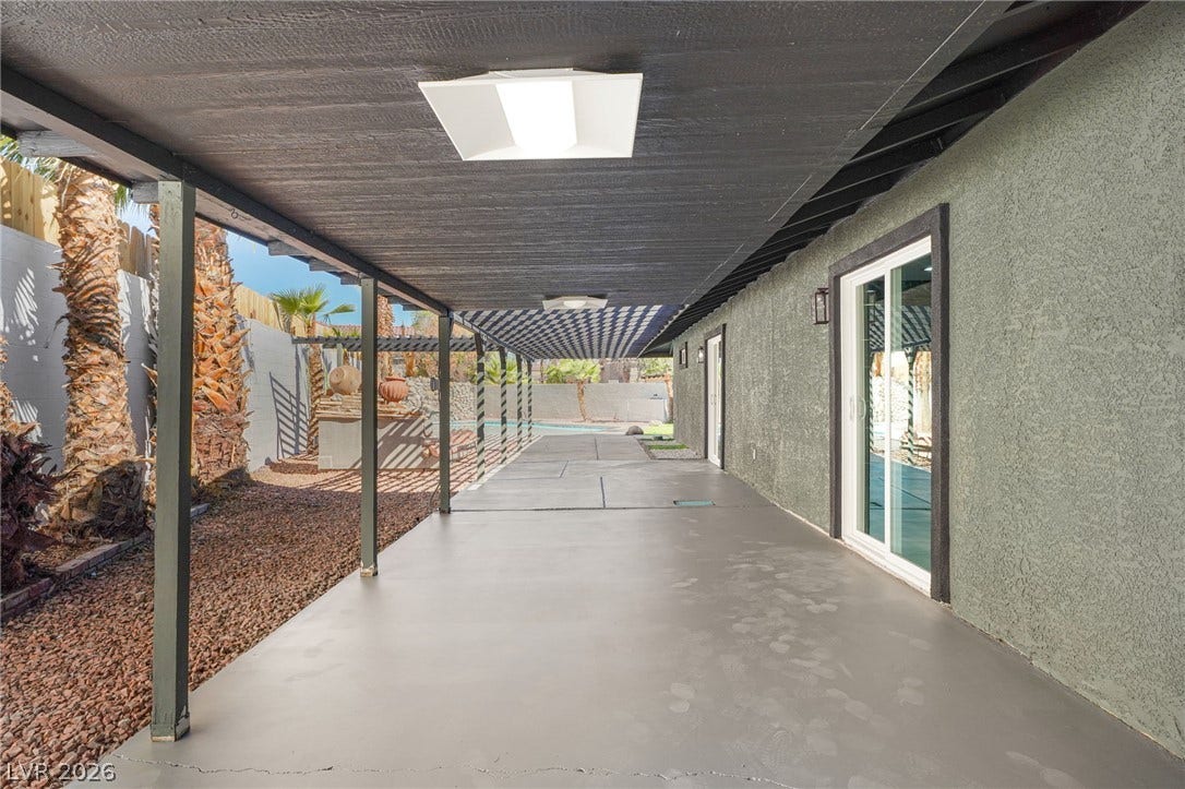 An expansive covered patio provides direct access to the outdoors through sliding glass doors.