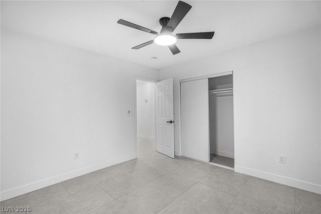 Large tile flooring and a built-in closet define this versatile room.