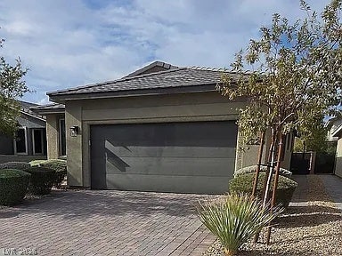2126 Albury Avenue, North Las Vegas, NV 89086 Clean lines and a spacious paver driveway define this modern exterior design.