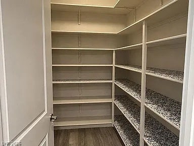 2126 Albury Avenue, North Las Vegas, NV 89086 Ample built-in shelving and durable wood flooring maximize storage efficiency in this walk-in pantry.