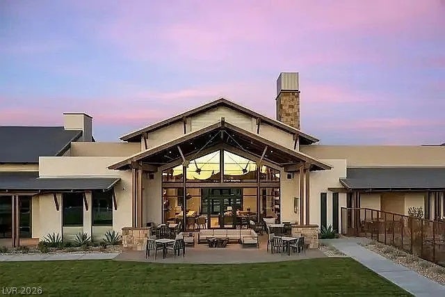 2126 Albury Avenue, North Las Vegas, NV 89086 Dramatic timber framing and soaring glass walls frame the covered outdoor entertaining area.