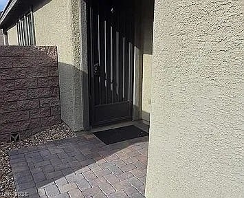 2126 Albury Avenue, North Las Vegas, NV 89086 An inviting gated courtyard entryway features clean stucco siding and custom paver stone flooring.