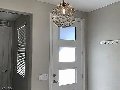 2126 Albury Avenue, North Las Vegas, NV 89086 An inviting entryway features a modern front door with three frosted privacy glass inserts.