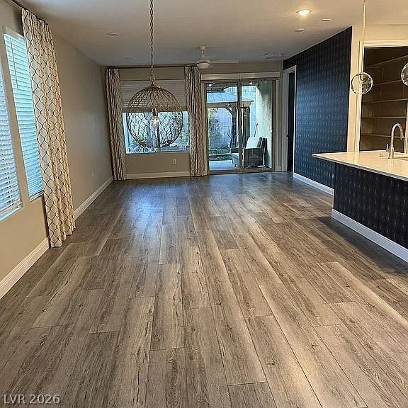 2126 Albury Avenue, North Las Vegas, NV 89086 Wood-look flooring runs throughout this open dining and living space leading to the patio.