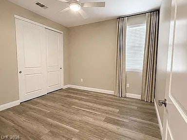2126 Albury Avenue, North Las Vegas, NV 89086 Smooth wood-look flooring and a classic window setup define this inviting bedroom space.