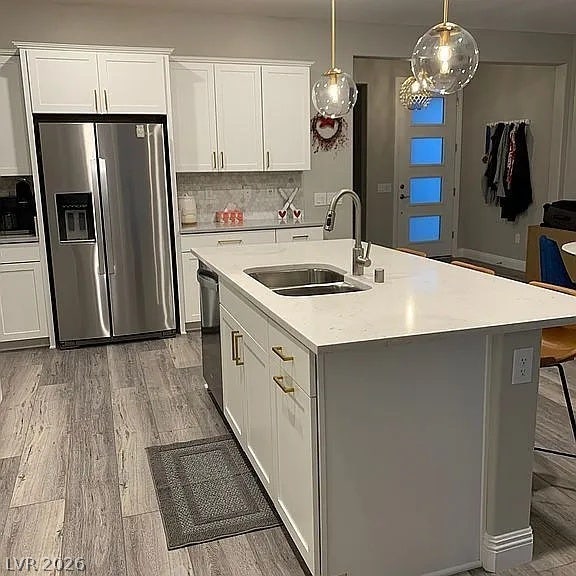 2126 Albury Avenue, North Las Vegas, NV 89086 Gleaming stone countertops and a central island anchor this modern culinary workspace.